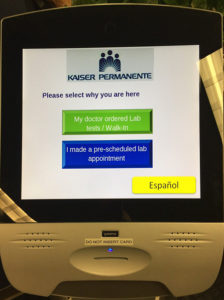 Green and blue buttons on Qmatic kiosk screen. 