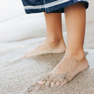 Child with feet in the sand