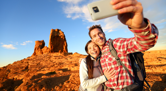 Hikers in desert taking a selfie photograph