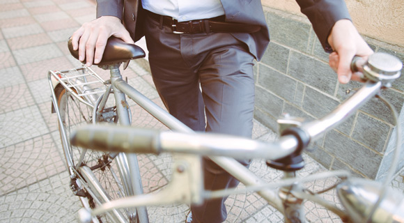Man in business suit with bike