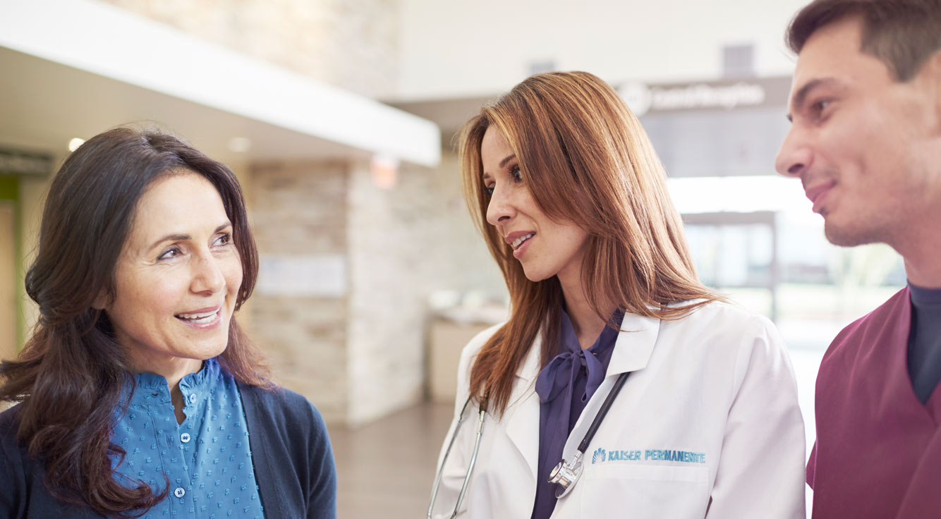 Female physician greets female patient.