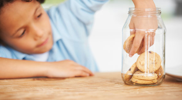 Child reaching into cookie jar