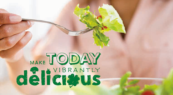 Woman eating a salad with text over image 