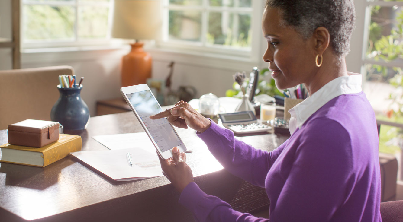 A businesswoman uses a tablet.