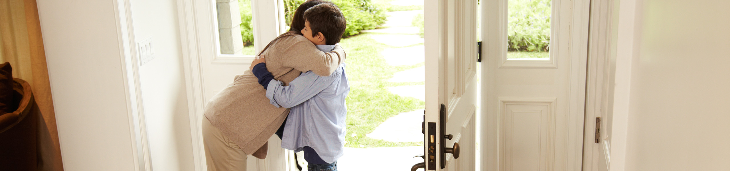 parent hugging their child goodbye at the door