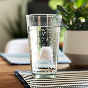 A glass of sparkling water on a table