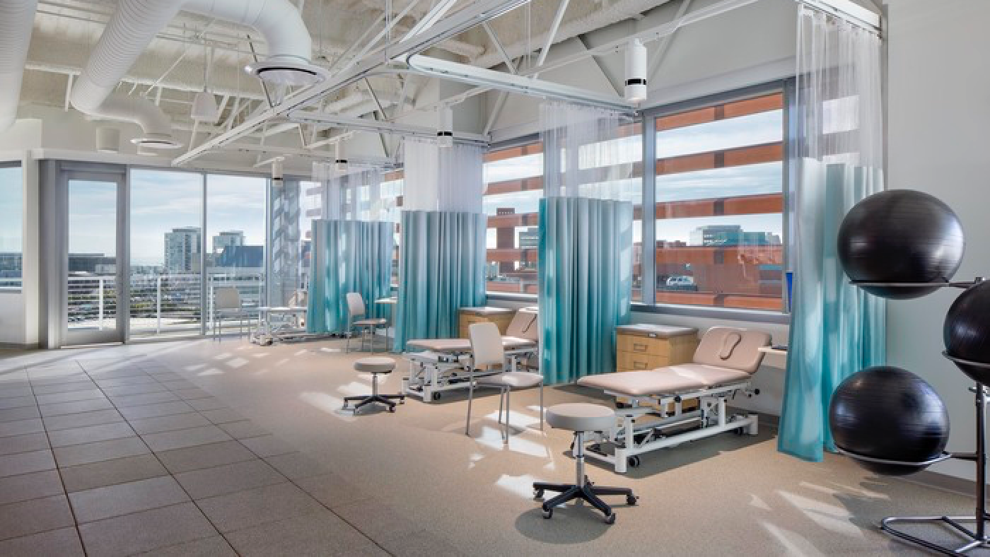 Bright airy rehabilitation treatment spaces with floor to ceiling windows and a balcony